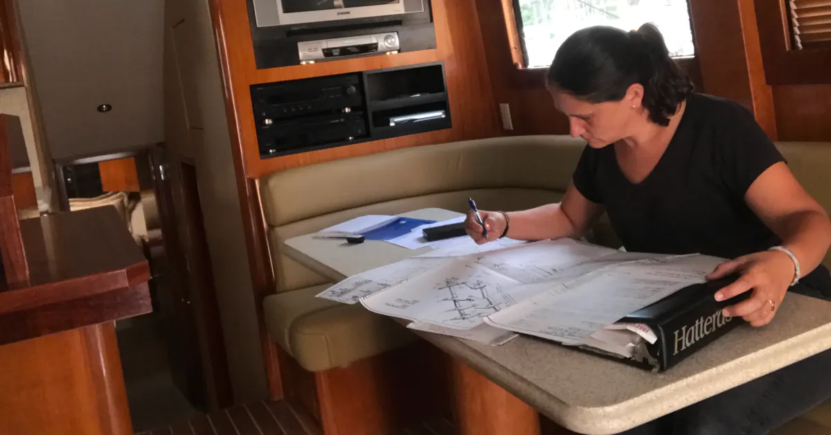 Ariadna reviewing technical drawings inside a vessel